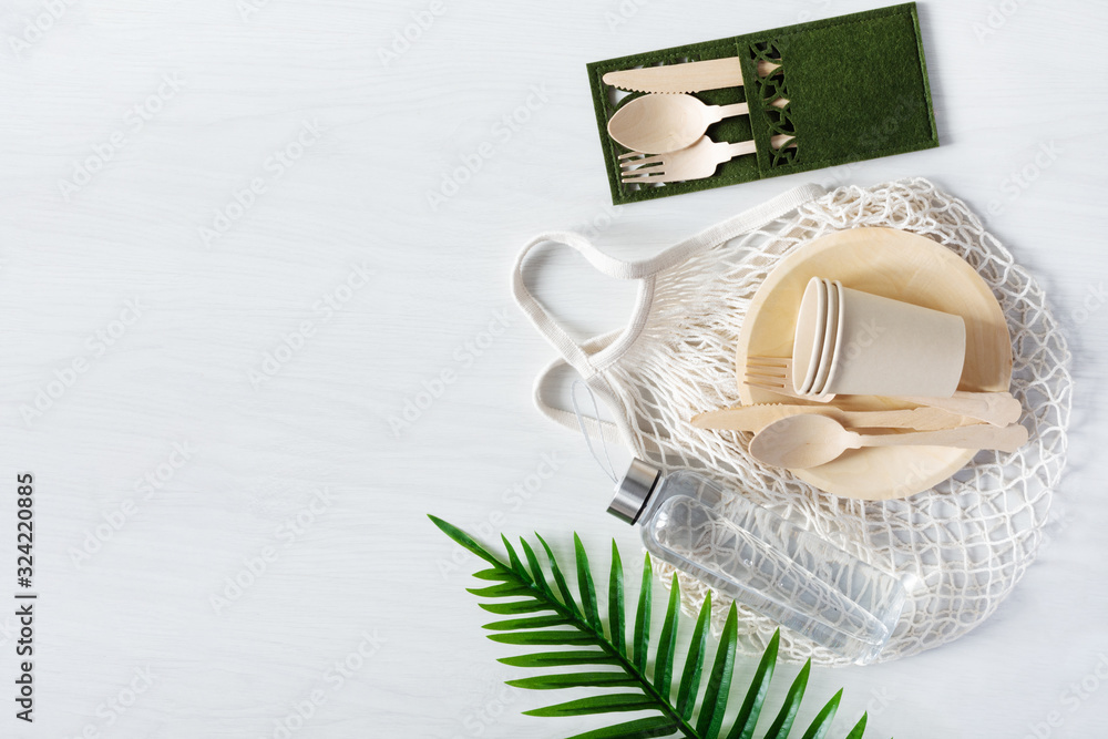 Cotton mesh bag for shopping and disposable tableware. Zero waste, plastic free concept. Cotton mesh bag for shopping and disposable tableware. Zero waste, plastic free concept.
