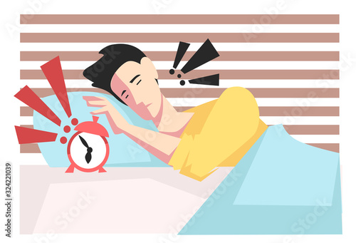 Waking up with alarm clock, man stressing in bed