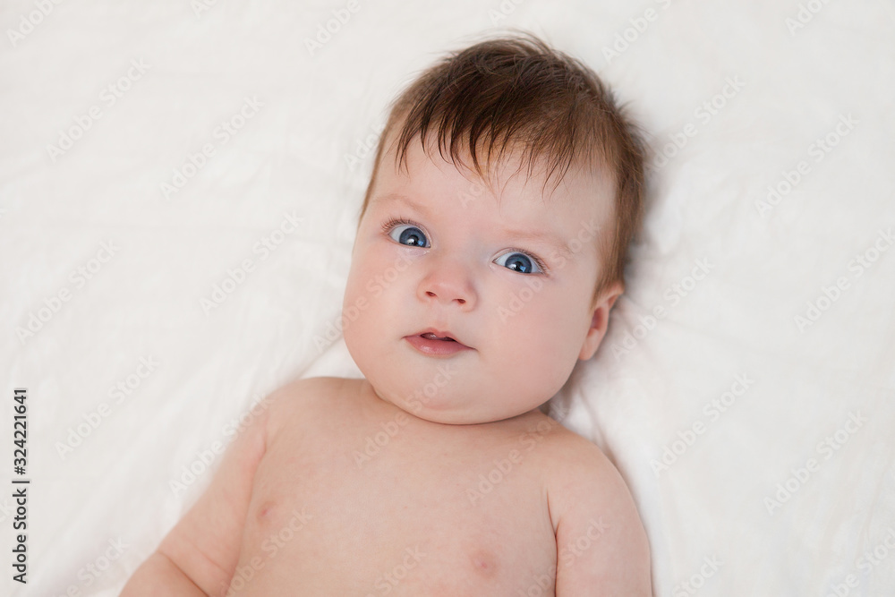 Newborn child relaxing in bed. Newborn child relaxing in bed.