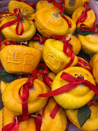 Lunar new year fruits at Tiong Bahru market - Pumpkin growing in shape of gold representing wealth and prosperity photo