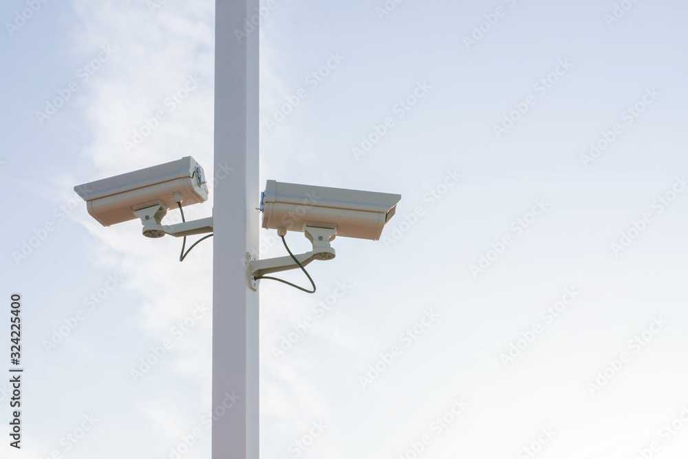 Closeup of traffic security camera on blue sky, Camera surveillance monitoring (CCTV) Closeup of traffic security camera on blue sky, Camera surveillance monitoring (CCTV)