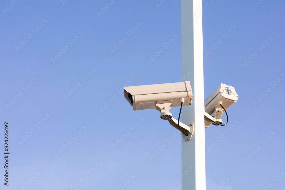 Closeup of traffic security camera on blue sky, Camera surveillance monitoring (CCTV) Closeup of traffic security camera on blue sky, Camera surveillance monitoring (CCTV)
