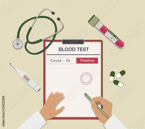 Top view of a doctor's desk. Blood tube, coronavirus test, stethoscope, pills and thermometer. Covid-19