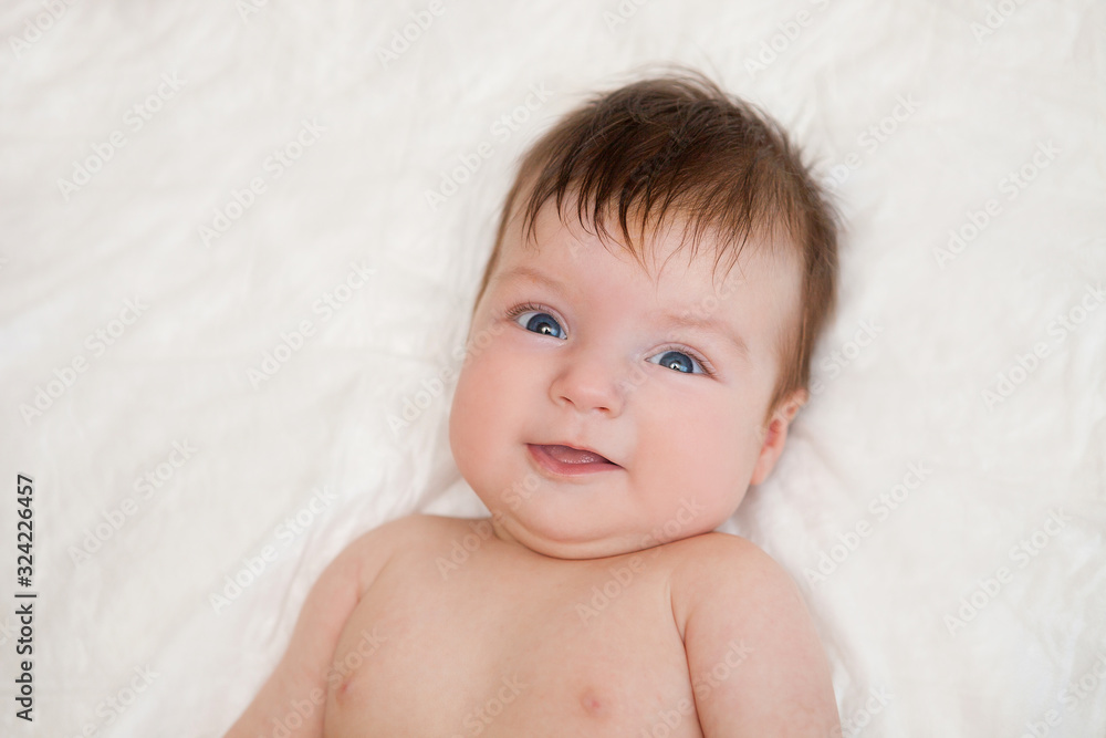 Newborn child relaxing in bed. Newborn child relaxing in bed.