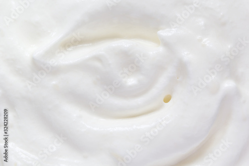 Whipped cream swirl texture. White soft dairy product. Cooking food background. Top view