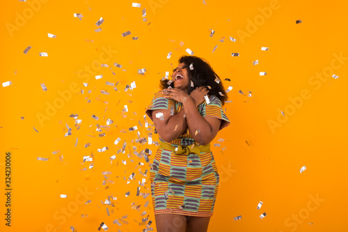 Party, holidays and birthday concept - Celebrating happiness, young woman dancing with big smile throwing confetti