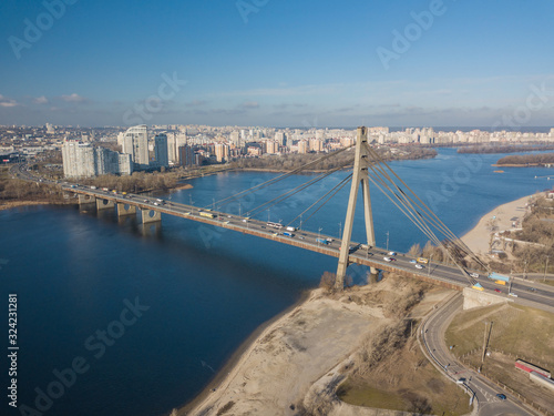 Aerial drone view. North bridge over the Dnieper river in Kiev in early spring on a sunny morning.