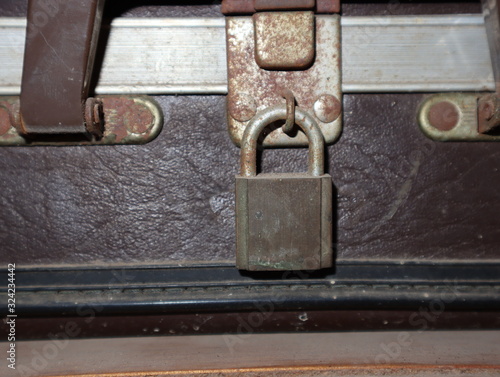 Old key lock on a suitcase for travel. © Phetmanee
