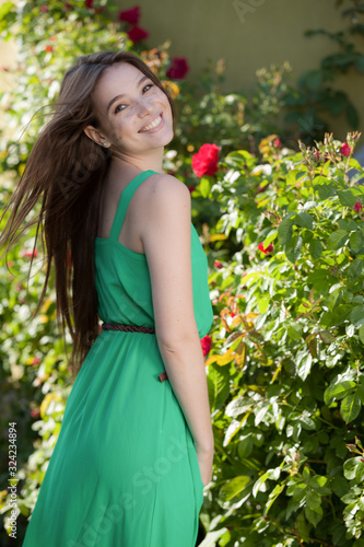 Portrait of beautiful young girl in summer garden.