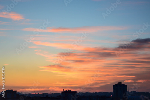 Beautiful dawn over the city. View from above. Cloudy sky. © Anastasia