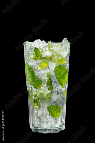 Summer drink with lime and mint, ice on isolated black background. Direct perspective, cool, refreshing