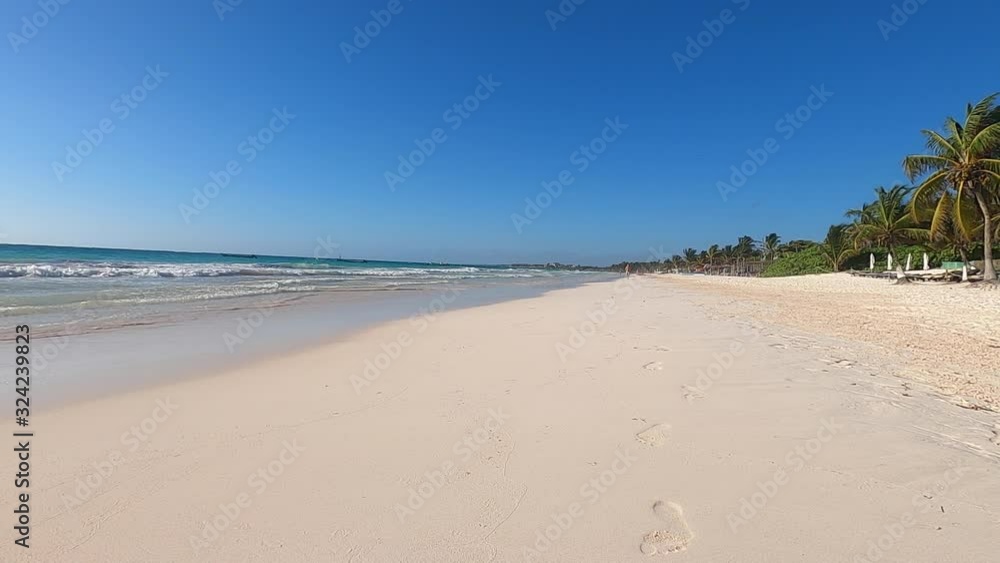 young woman runs on the beach in Tulum Mexico at first light of the day. Slow motion video of the waves by the sea young woman runs on the beach in Tulum Mexico at first light of the day. Slow motion video of the waves by the sea