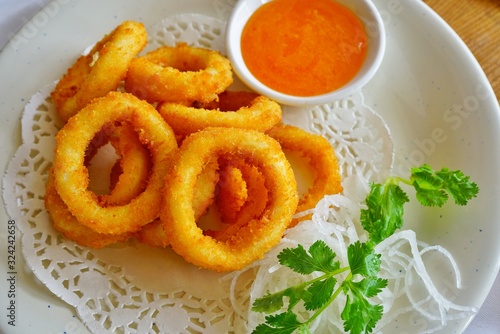 Fried calamari rings with a sweet and sour sauce at a Japanese sushi restaurant