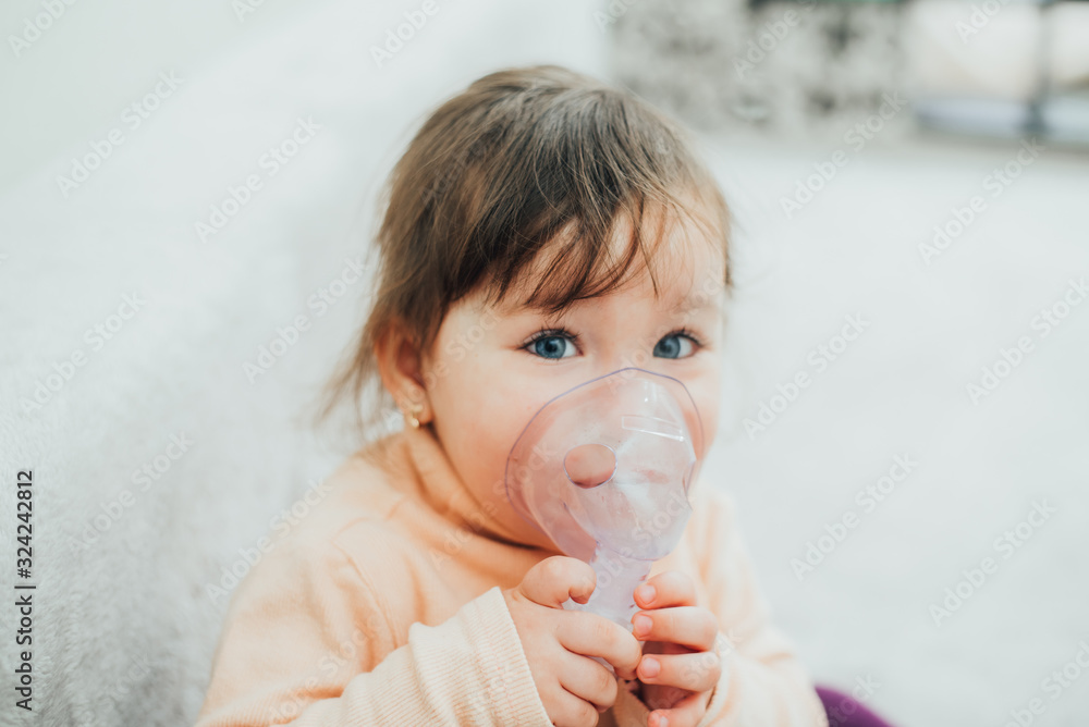 The girl makes an inhalation for coughing on her own