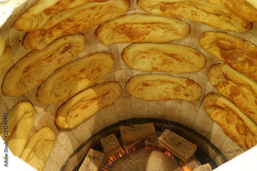 Many of Armenian traditional breads baked in a modern gas tonir oven photo