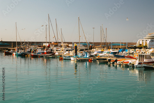 Cute colorful boats in a harbour © Charlotte