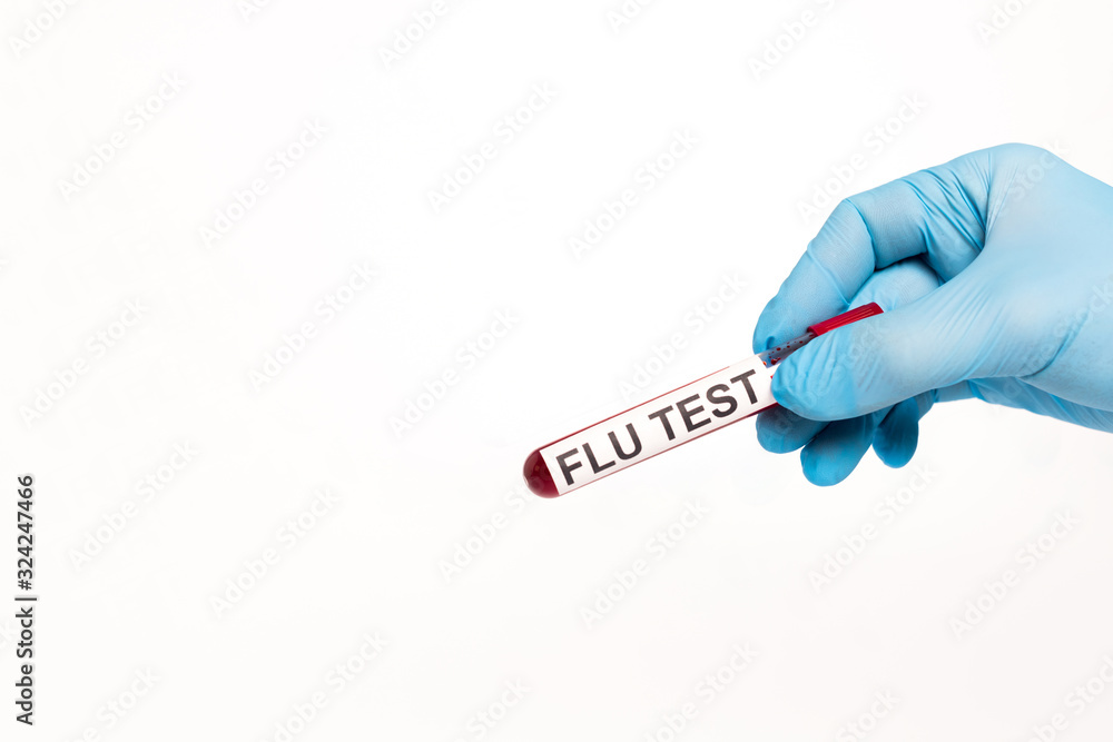 Obraz premium cropped view of scientist holding test tube with flu test lettering isolated on white