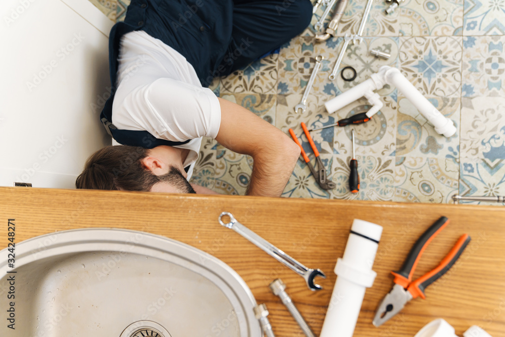 Plumber work in uniform indoors. Plumber work in uniform indoors.