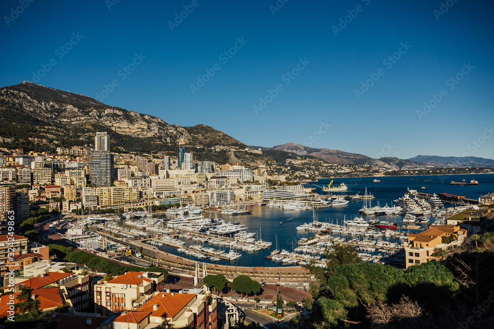 Monte Carlo city panorama. View of luxury yachts and apartments in harbor of Monaco, Cote d'Azur. Panorama Port Hercules from the observation deck in Monaco.