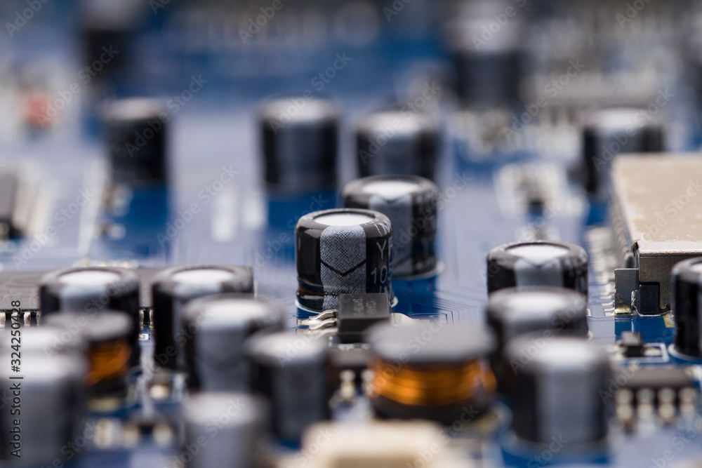 Naklejka premium circuit board with dip components. Close-up capacitors on a circuit board