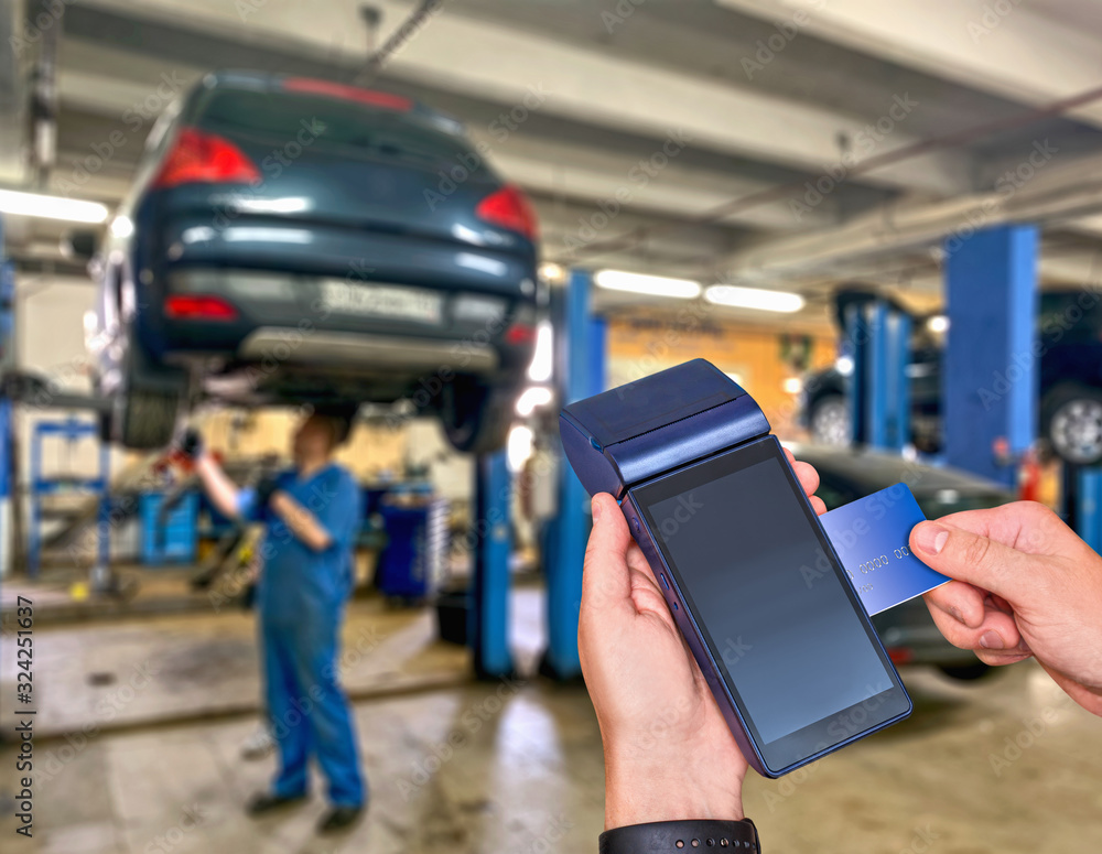 Car service payment of car repair card with the payment terminal. All  silhouettes of cars are distorted for unrecognizability. Stock Photo |  Adobe Stock