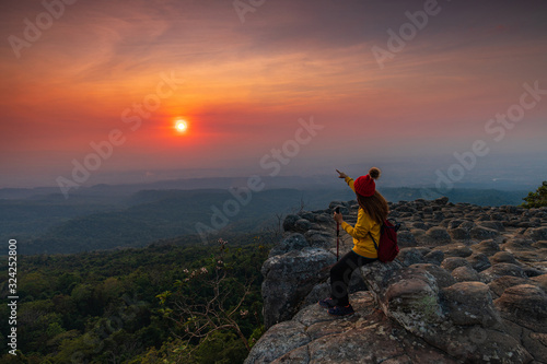 Young  woman hiking on mountains. Lan-hin-pum, Phu Hin Rong Kla National park, Phitsanulok province , Thailand.