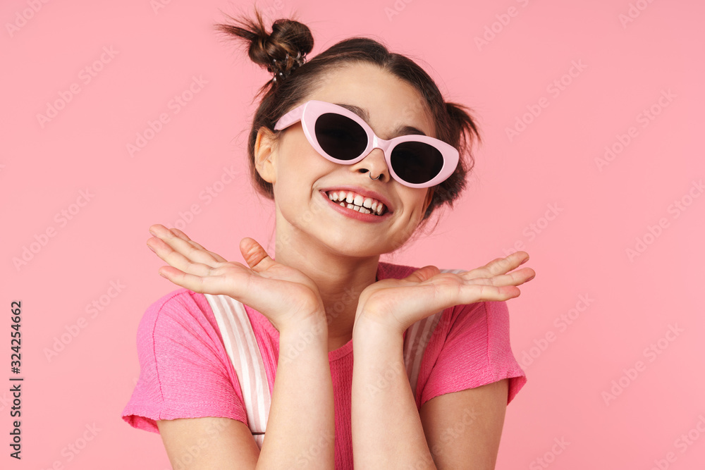 Photo of joyful charming girl in sunglasses posing and laughing Photo of joyful charming girl in sunglasses posing and laughing