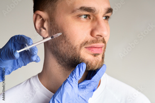 Doctor making beauty injection guy. Anti aging procedure