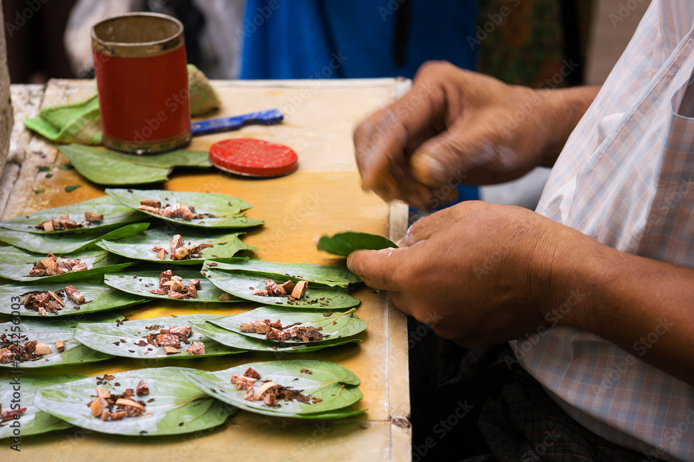 Men preparing betel chew, Myanmar. - obrazy, fototapety, plakaty 