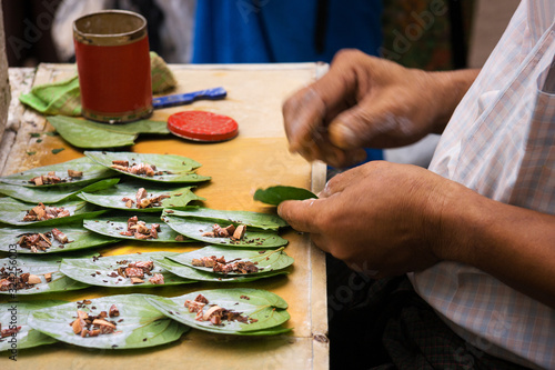 Fotografie Men preparing betel chew, Myanmar.