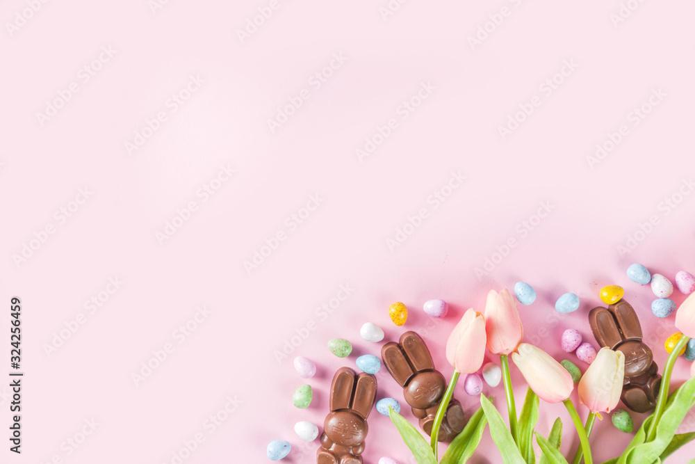 Easter composition with chocolate eggs and bunny rabbits, flatlay copy space
