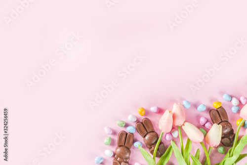Easter composition with chocolate eggs and bunny rabbits, flatlay copy space