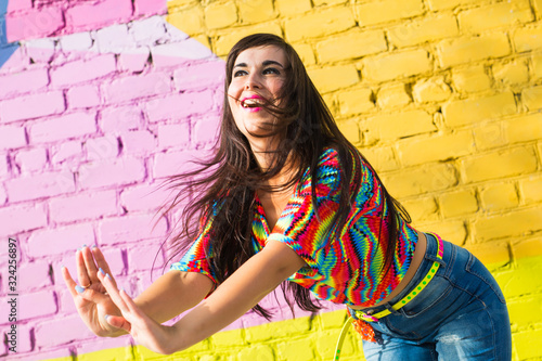 Street shaabi dance and urban dancer concept - Cheerful belly dancer dancing with arabic music on the street photo