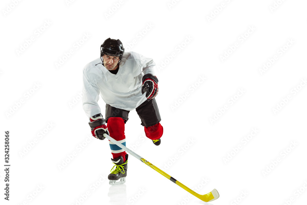 Speed. Young male hockey player with the stick on ice court and white background. Sportsman wearing equipment and helmet practicing. Concept of sport, healthy lifestyle, motion, movement, action.