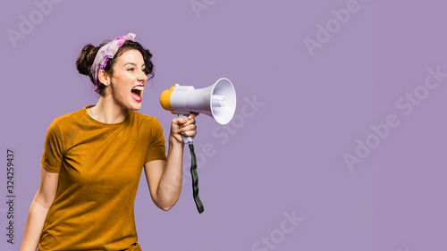 Woman shouts in megaphone with copy space photo