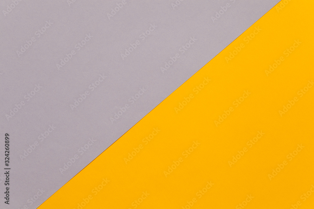 Background of two sheets of colored paper, light purple and yellow.