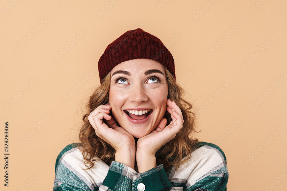 Photo of pretty happy woman in knit hat posing and smiling at camera Photo of pretty happy woman in knit hat posing and smiling at camera