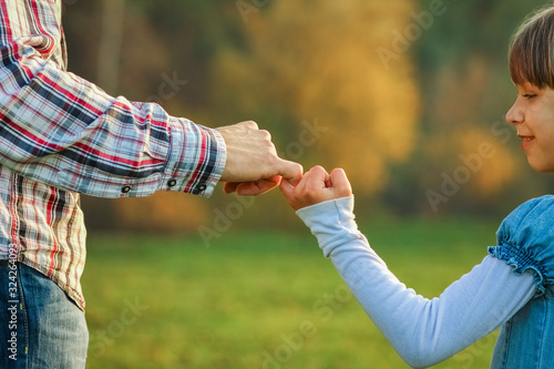 a beautiful hands of parent and child outdoors in the park