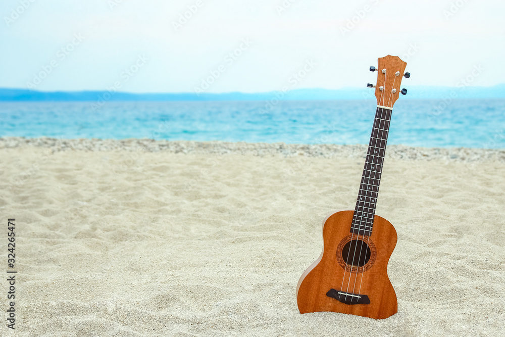 Fototapeta beautiful guitar on the sand by the Greek sea