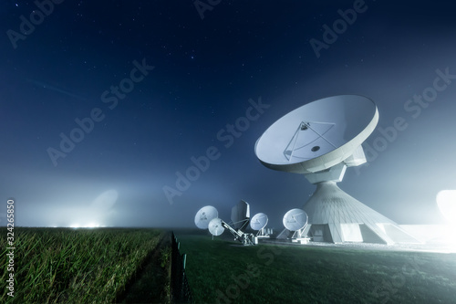 Fototapeta Naklejka Na Ścianę i Meble -  Satellite dishes at Raisting earth station in a foggy night