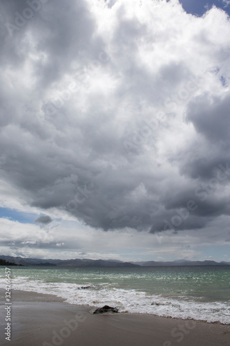 Coromendel coast New Zealand. Clouds and waves