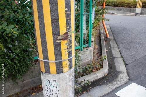 車が擦った跡がある電柱 photo