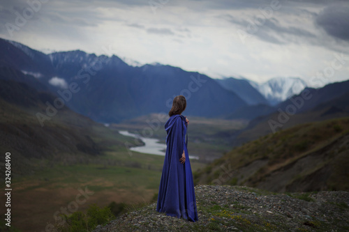 A girl walks in the mountains.