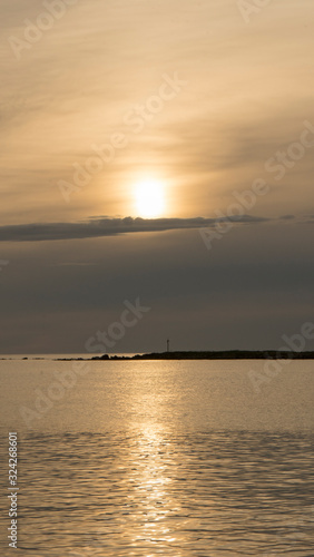 Emotional shot of a bay at sunrise or sunset in backlight with very cloudy sky © Robby Fontanesi
