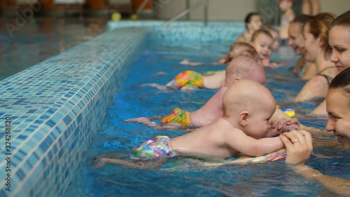 Group of mothers with children in the pool photo