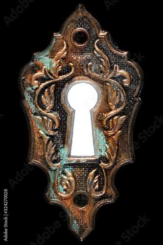 Bright light in the keyhole, decorative design element, isolated on black background