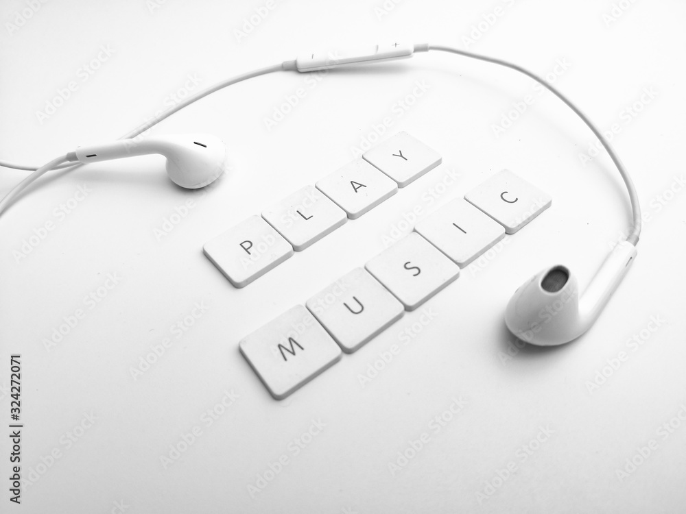 Earphone and alphabet wording sort PLAY MUSIC over white background Earphone and alphabet wording sort PLAY MUSIC over white background