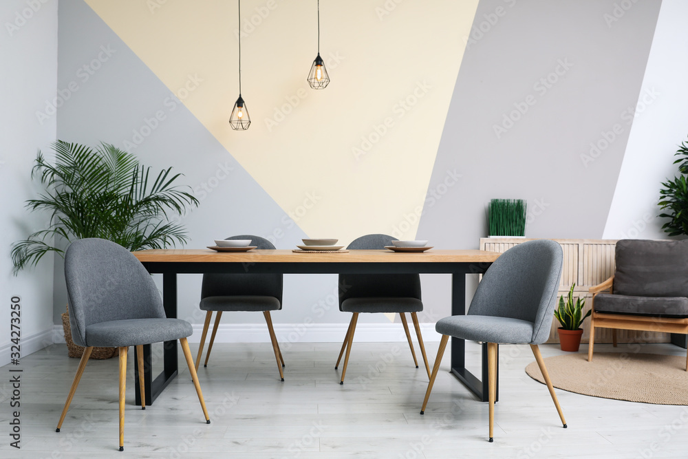 Modern wooden dining table in room interior Modern wooden dining table in room interior