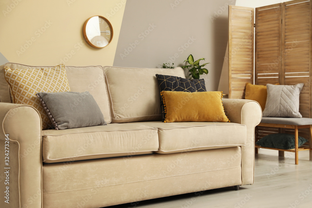 Modern comfortable sofa with pillows indoors. Stylish room interior Modern comfortable sofa with pillows indoors. Stylish room interior