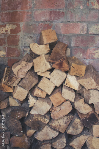 Firewood laying in a pile within brick wood store.